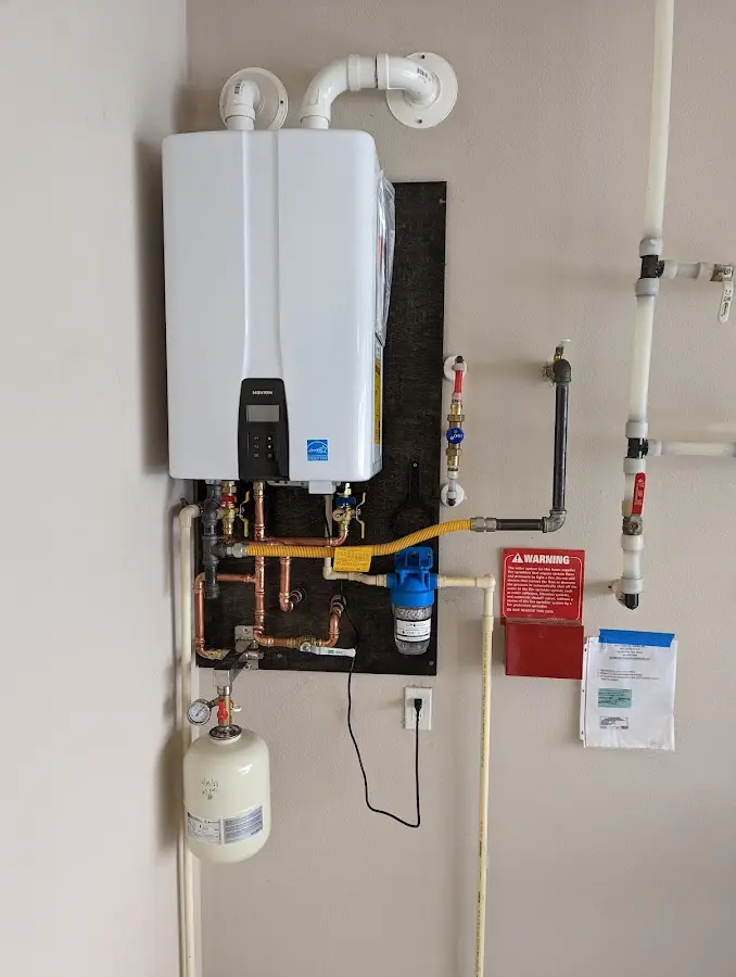 Professional plumber installing copper piping in a Cotati home